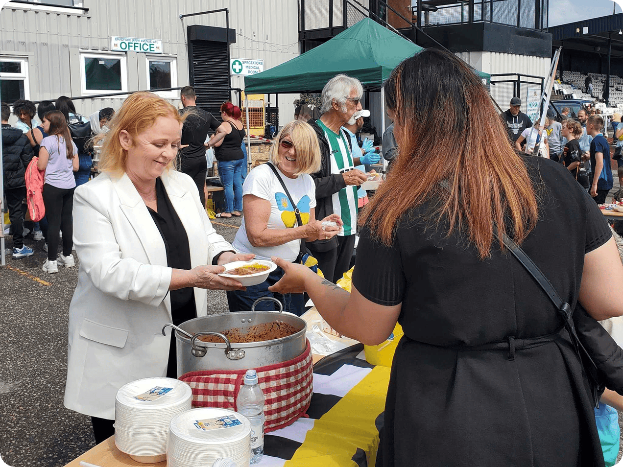 Person serving food at outdoor event